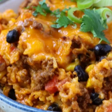 Delicious beef enchilada casserole layered with rice and savory toppings.