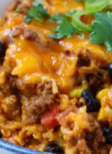 Delicious beef enchilada casserole layered with rice and savory toppings.