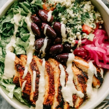 Cozy chicken shawarma meal prep bowl with colorful vegetables and sauce