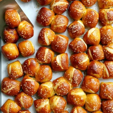 Cozy homemade pretzel bites served with mustard dip on a wooden table.