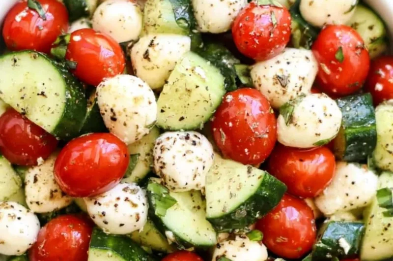 Fresh Cucumber Caprese salad with mozzarella and basil on a plate.