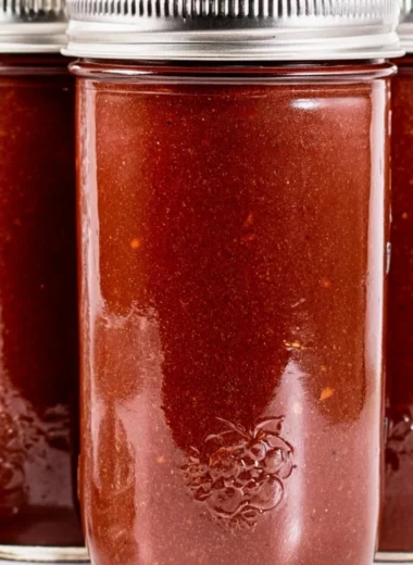 Bowl of homemade BBQ sauce with fresh ingredients and herbs