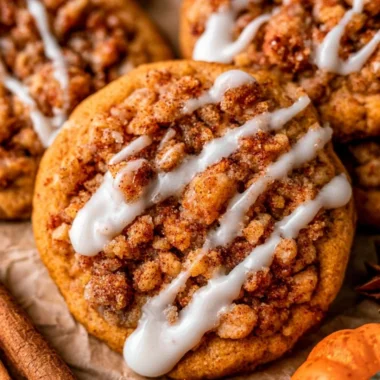 Plate of freshly baked pumpkin coffee cake cookies with icing on top.