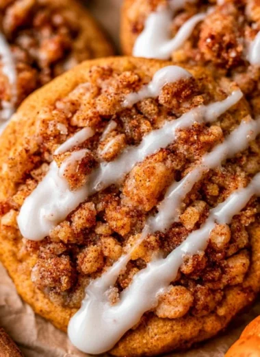 Plate of freshly baked pumpkin coffee cake cookies with icing on top.