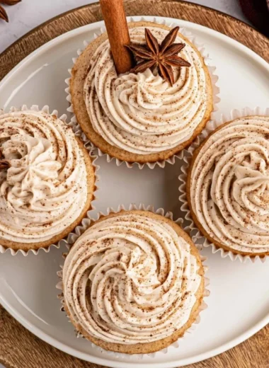 Spiced chai latte cupcakes topped with cream and spices