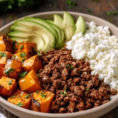 Hot honey sweet potato beef bowls garnished with fresh herbs.