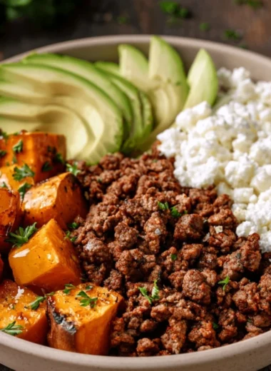 Hot honey sweet potato beef bowls garnished with fresh herbs.